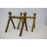 A pair of late 19th century Arts and Crafts brass fire dogs, with turned finials and turned