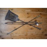 A set of three 19th century steel fire irons, the brass handles decorated flowers and foliage, the