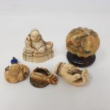 A Japanese carved ivory netsuke, in the form of a Buddha, 5 cm high, and others similar