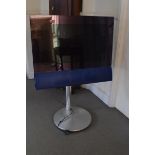 A Bang & Olufsen BeoCenter colour TV, with a blue speaker grill, on a motorised stand (no remotes)
