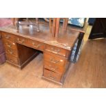 A mahogany pedestal desk, having an arrangement of nine drawers, 122 cm wide