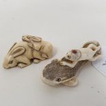 A Japanese carved ivory netsuke, in the form of two rabbits, 4.5 cm wide, and a Japanese carved