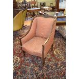 An Edwardian mahogany armchair, on turned front legs