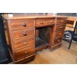 A mahogany desk, of inverted breakfront form, having an arrangement of nine drawers, 122 cm wide