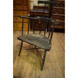 A painted primitive stick back armchair, the solid seat on tapering legs joined by a shaped X