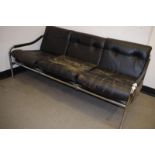 A Pieff three seater low settee, with leather cushions and a chrome tubular frame, bought from Heals