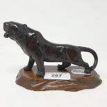 A Japanese bronze figure, of a snarling tiger, impressed seal mark, Meiji period, 8 cm high, on a