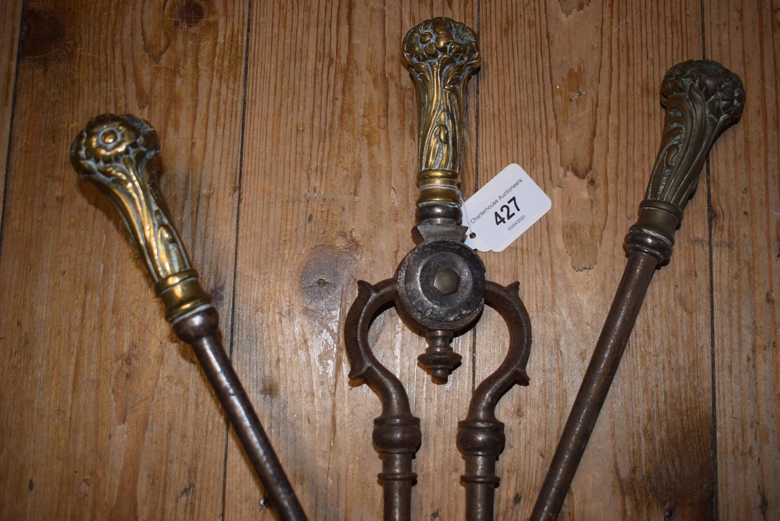 A set of three 19th century steel fire irons, the brass handles decorated flowers and foliage, the - Image 2 of 2