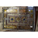 A stained glass lead panel, 47 x 66.5 cm, a dressing mirror, and an iron and glass light fitting,