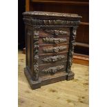 A late 19th century Anglo-Flemish carved oak Wellington chest, having five graduated long drawers,