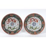 A pair of Chinese porcelain plates, decorated dragons chasing flaming pearls, flowers and foliage, a