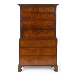 A tallboy chest on chest, veneered in walnut, the molded cornice above two short and three graduated