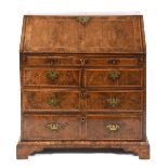 An early 18th century bureau, veneered in walnut and with feather crossbanding, the fall front