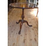 A George III mahogany tripod table, the dished top on a baluster turned column, 55 cm diameter