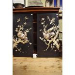 A pair of Japanese black laquer and Shibayama style panels, decorated birds and foliage, signed, 106