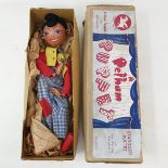 A Pelham puppet, Boy, in a brown box