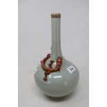 A Chinese celadon ground bottle vase, with a slender neck, applied a Chilong dragon with gilt
