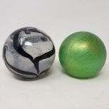 An R Ditchfield Glasform iridescent glass paperweight, of almost spherical form with striated
