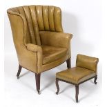 A 19th century leather upholstered wing armchair, on tapering square front legs See illustration