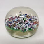 A Paul Ysart glass paperweight, the scrambled multi coloured cane ground with inset bubbles, applied