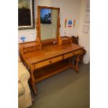 An Aesthetic Period ash dressing table, by Gillow, the mirror flanked by two small drawers, above