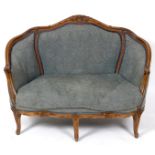 A pair of French carved beech two seater settees, on cabriole legs, with a matching pair of