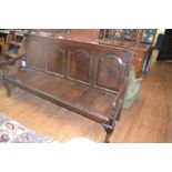 A 19th century oak settle, with a four panel back, on cabriole front legs with pad feet, 183 cm wide
