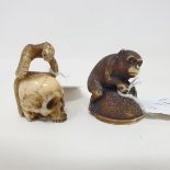 A Japanese carved and stained ivory netsuke, in the form of a monkey on a mound hiding an octopus,
