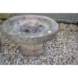 A pair of reconstituted stone garden urns, of oval form, 59 cm wide x 43 cm high, three graduated