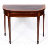 A George III mahogany D shaped card table, crossbanded in satinwood, on tapering square legs with