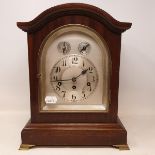 An early 20th century mantle clock, the 16 cm arched silvered dial with Arabic numerals and