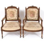 A pair of French walnut and parcel gilt fauteuil, carved ribbon ties and acanthus leaves, on
