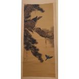 A Japanese painted hanging scroll, decorated with an eagle in a pine tree, signed, the image 93 cm x