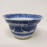 An 18th century Chinese blue and white tea bowl, with scalloped border with hand painted and moulded