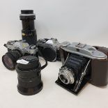 A Canon AE-1 camera, another, various lenses, accessories, and other cameras, (box)
