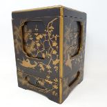 A Japanese lacquered cabinet, late 19th century, fitted with a series of lidded boxes, with a drawer