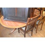 A Regency style mahogany twin pillar dining table, crossbanded in satinwood and with boxwood and