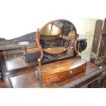 An early 19th century mahogany dressing mirror, the bow front box base with three drawers, 56 cm