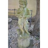 A reconstituted stone figure, depicting Winter, on an associated base and slab, 130 cm high (
