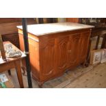 A French walnut cabinet, having a marble top above a pair of hinged double panel doors, on dwarf