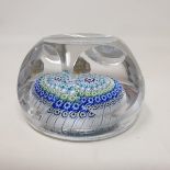 A Whitefriars Millefiore glass paperweight, with faceted sides and multi coloured circles of canes