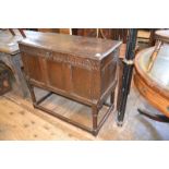 A carved oak coffer, on a later stand, 98 cm wide report by RB Old worm, top detached, needing a