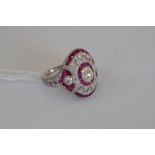 A platinum ruby and diamond ring, old cut central diamond approx 0.63ct, remaining diamonds