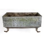 An 18th century style lead garden planter, decorated putti and dogs, on animal feet legs, 92 cm wide