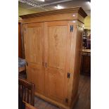 A modern light oak to door wardrobe, with a pair of panel doors, 129 cm wide