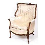 A Louis XVI style carved walnut armchair, on cabriole front legs with knurl feet See illustration