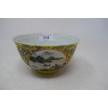 A Chinese porcelain medallion bowl, decorated vignettes of mountain scenes on a yelllow ground