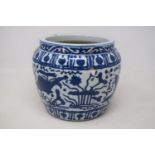 A Chinese pottery jardiniere, decorated fish and foliage in underglaze blue, 17.5 cm high