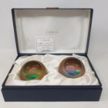 A pair of Caithness glass paperweights, Alpha & Omega set, designed by Colin Terris, limited edition