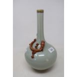 A Chinese celadon ground bottle vase, with a slender neck, applied a Chilong dragon with gilt